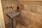 Stone Pedestal Sink with Tiled Wall